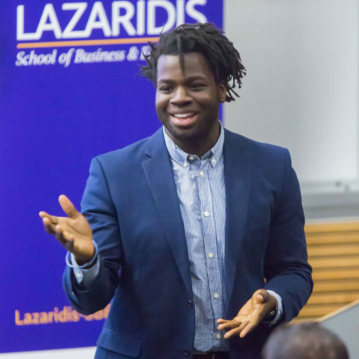 A Black male student giving a business presentation.